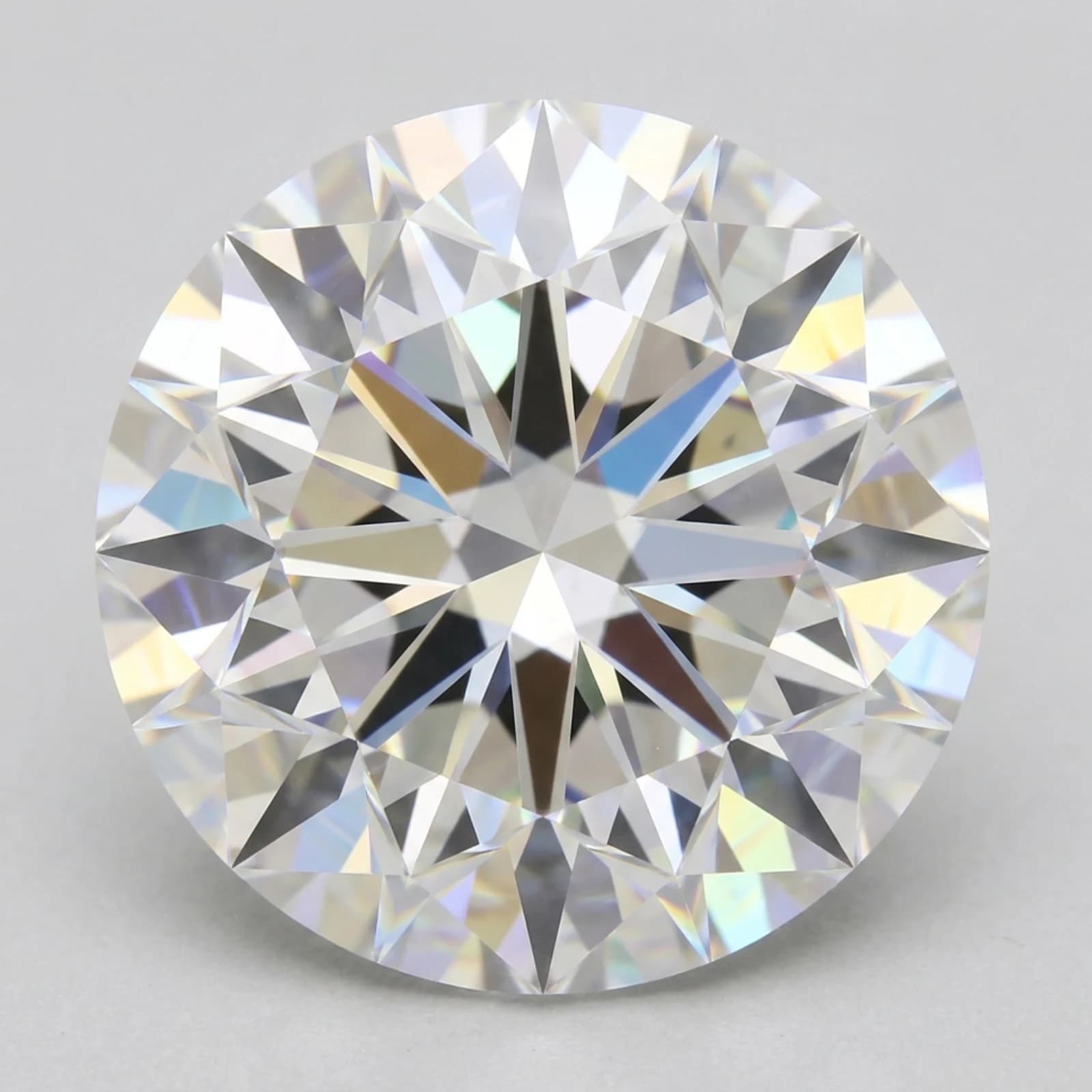 A round brilliant diamond seen face up, filling the frame, its facet pattern catching the light.
