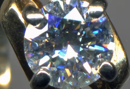 A loose round brilliant diamond photographed face up.