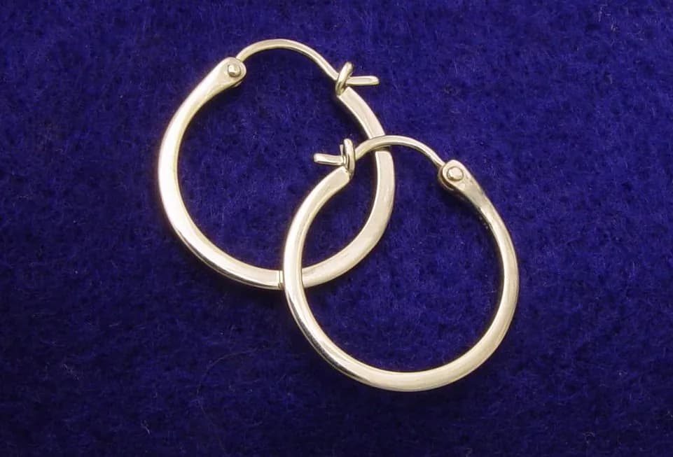 A pair of plain gold hoop earrings.